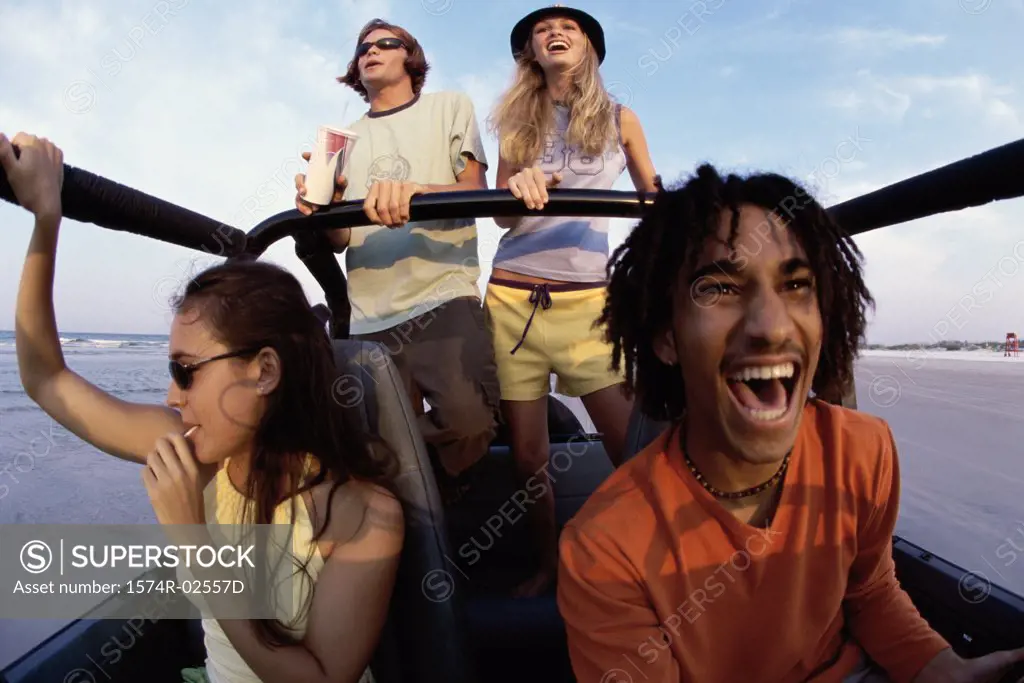 Low angle view of two young couples in a jeep
