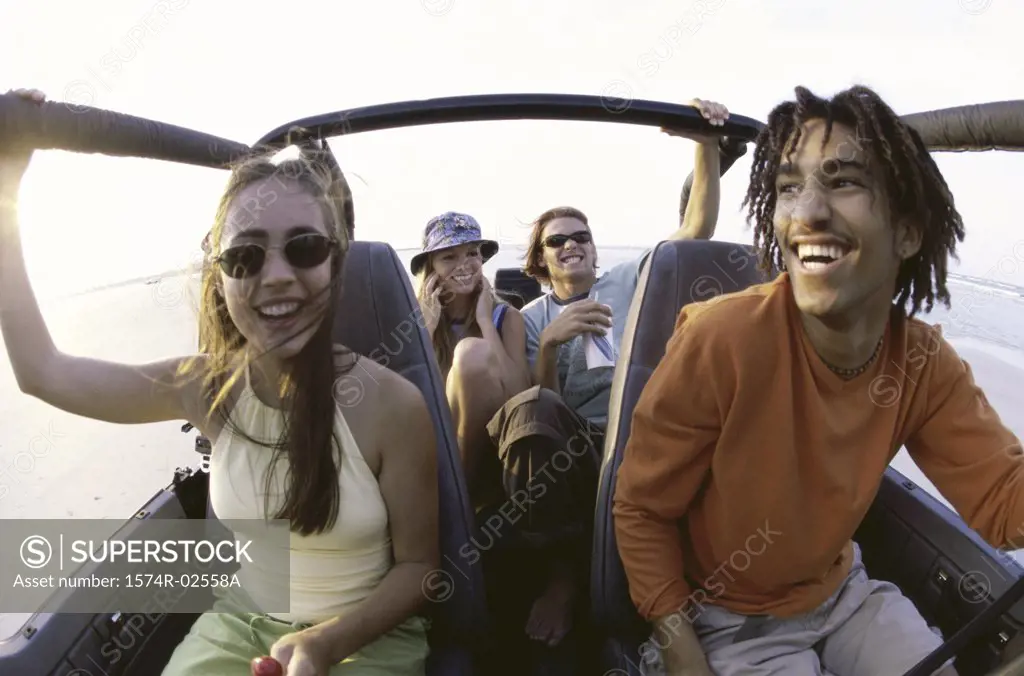 Two young couples sitting in a jeep