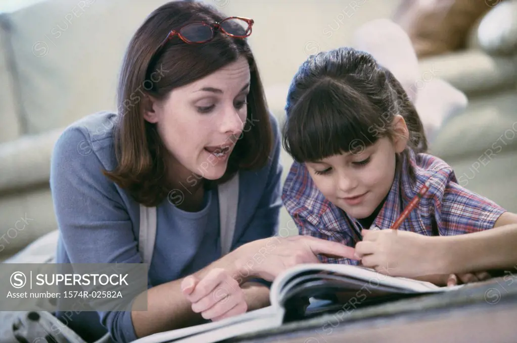 Mother assisting her daughter with her homework