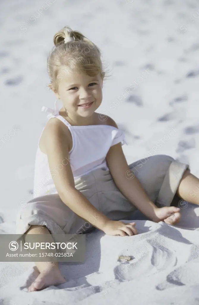 Portrait of a girl playing in the sand on the beach