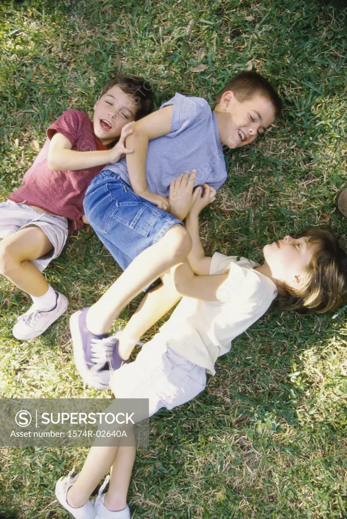 High angle view of a girl and two boys playing in a park