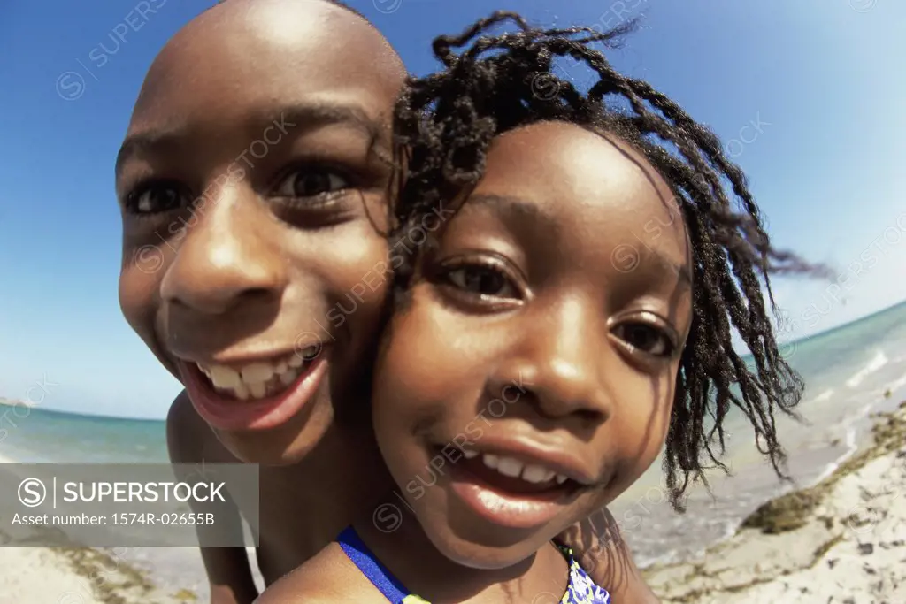 Portrait of a boy and a girl playing on the beach
