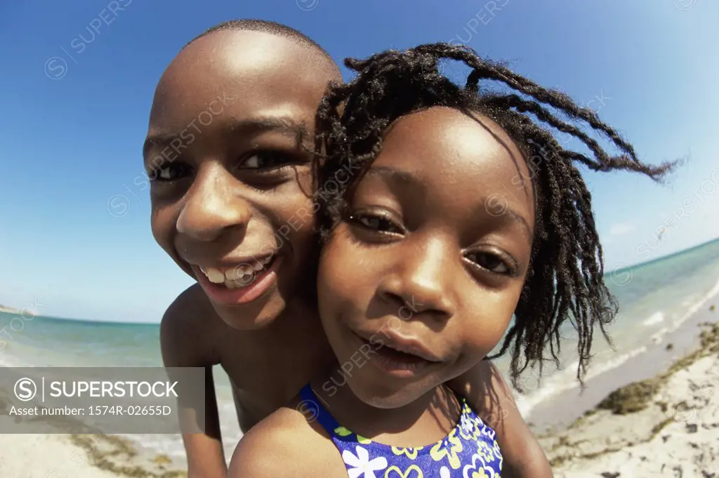 Portrait of a boy and a girl playing on the beach