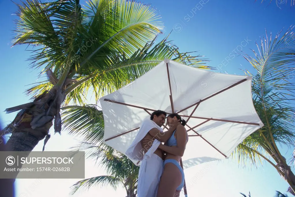 Low angle view of a young couple embracing on the beach