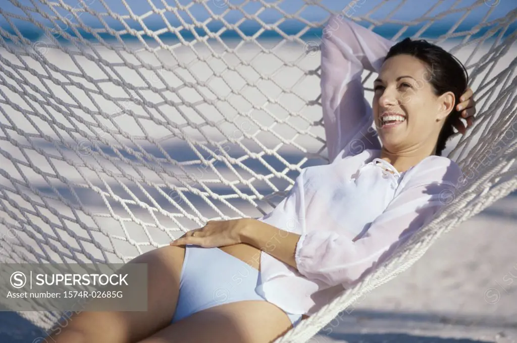 Young woman lying in a hammock