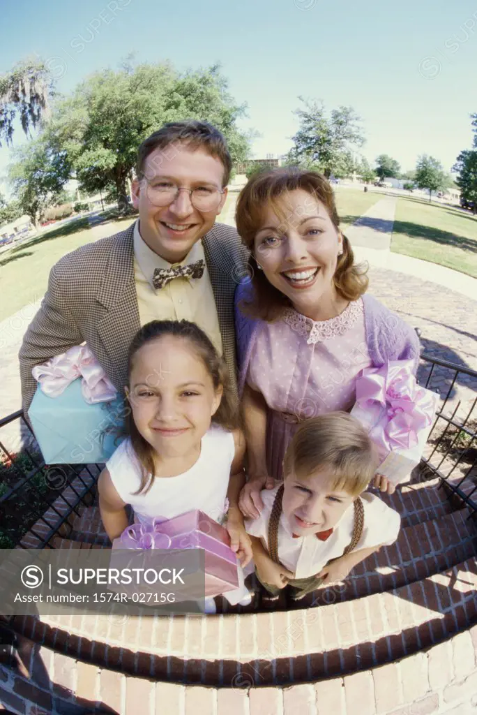 Portrait of parents standing with their son and daughter