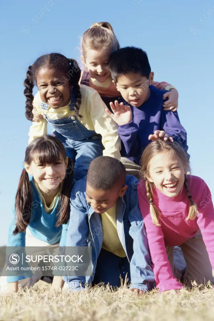 Portrait of a group of children making a human pyramid