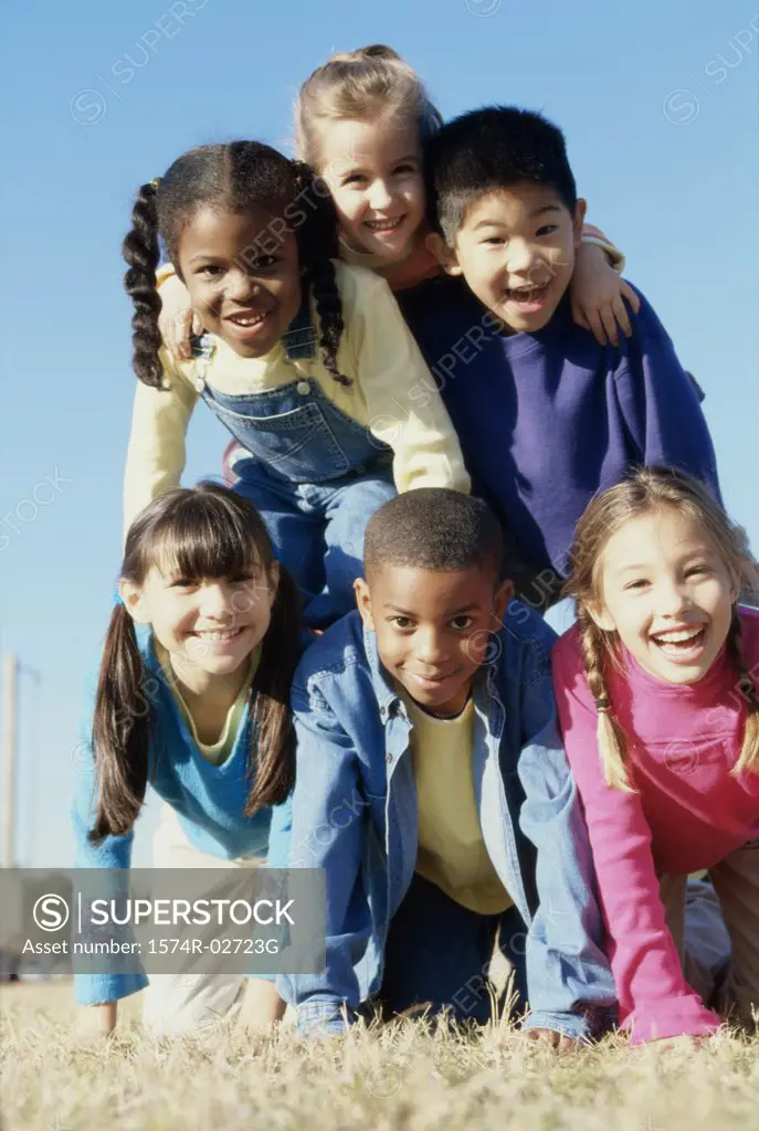 Portrait of a group of children making a human pyramid