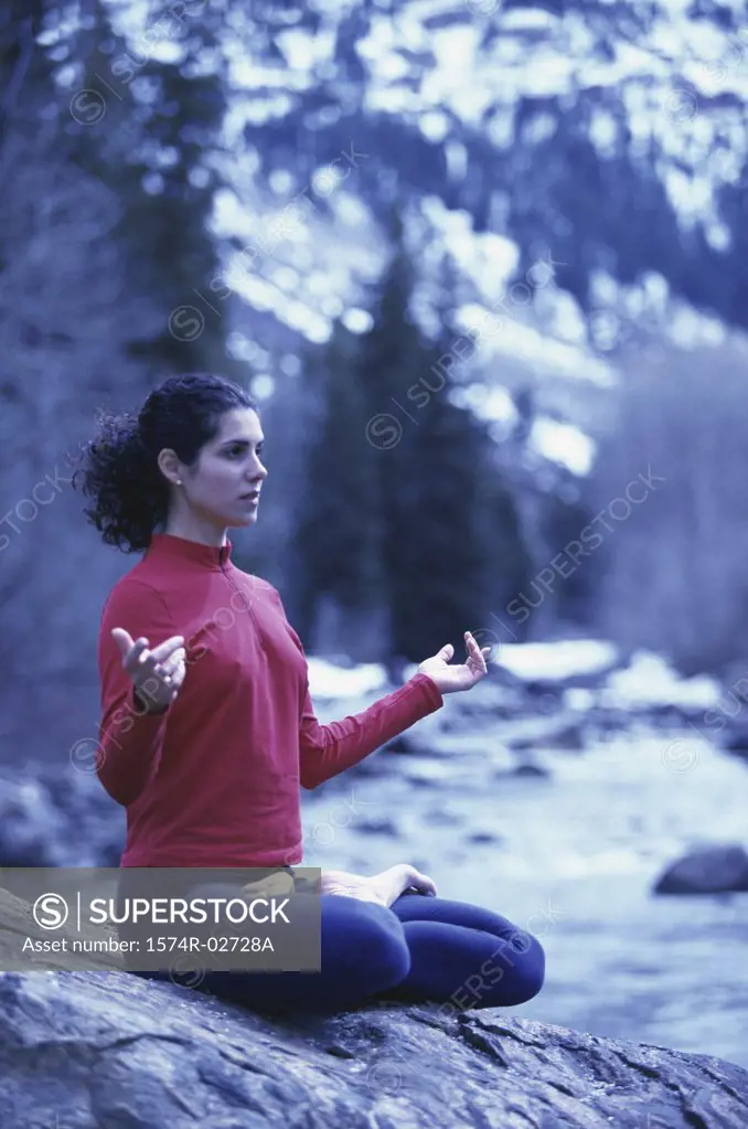 Young woman meditating in the lotus position