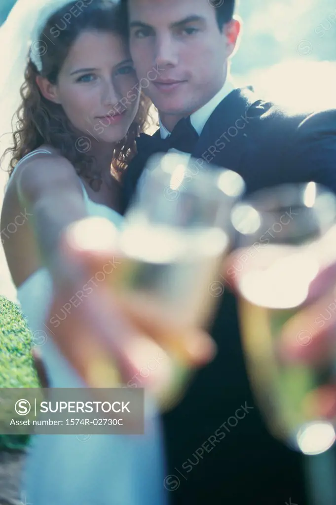 Portrait of a newlywed couple toasting with glasses of champagne
