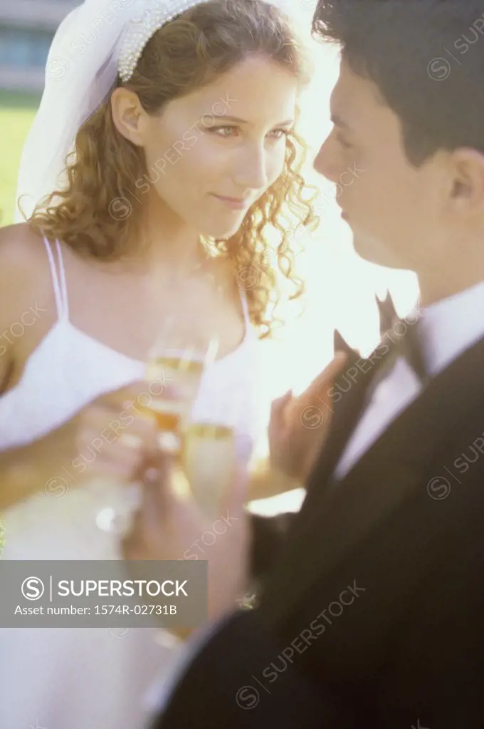 Close-up of a newlywed couple toasting with champagne glasses