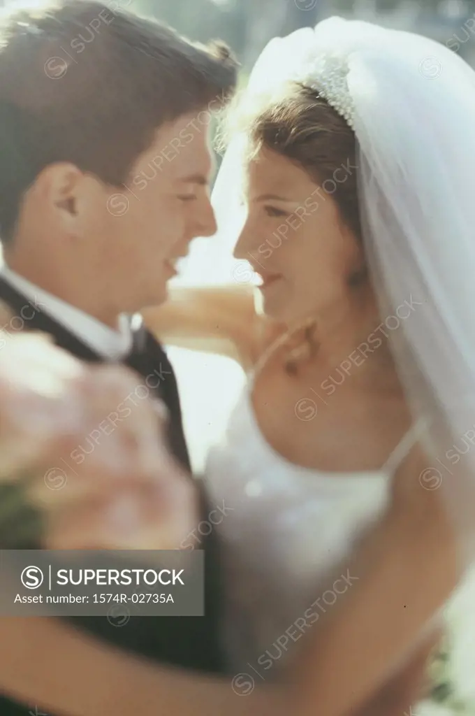 Close-up of a newlywed couple embracing each other