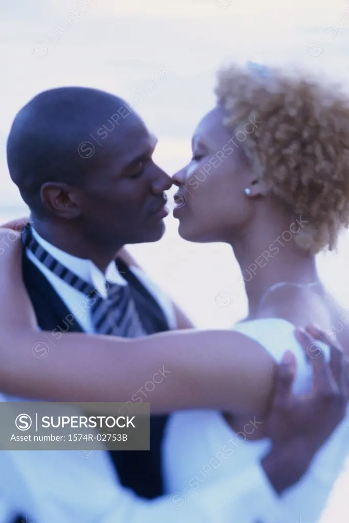 Newlywed couple kissing each other