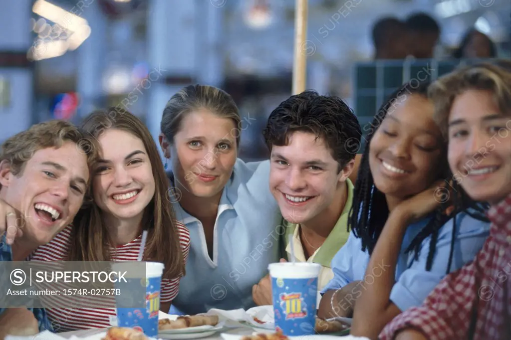 Portrait of a group of teenagers sitting in a restaurant