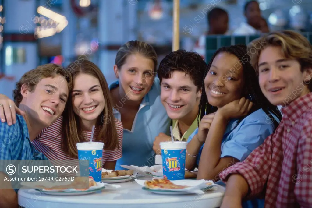 Portrait of a group of teenagers sitting in a restaurant