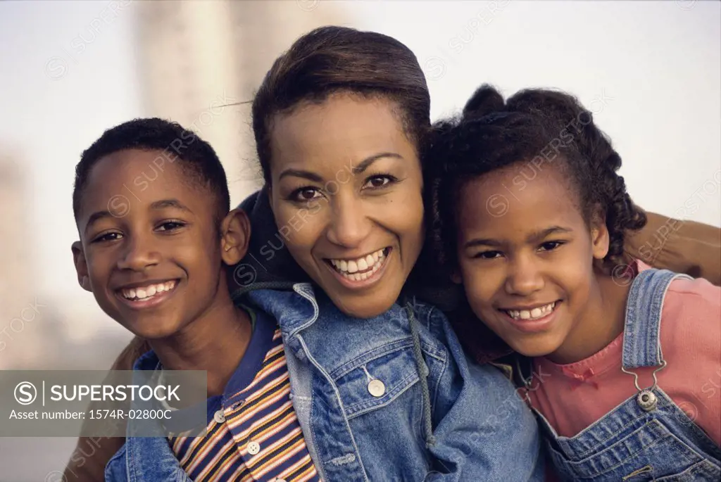 Portrait of a mother smiling with her son and daughter