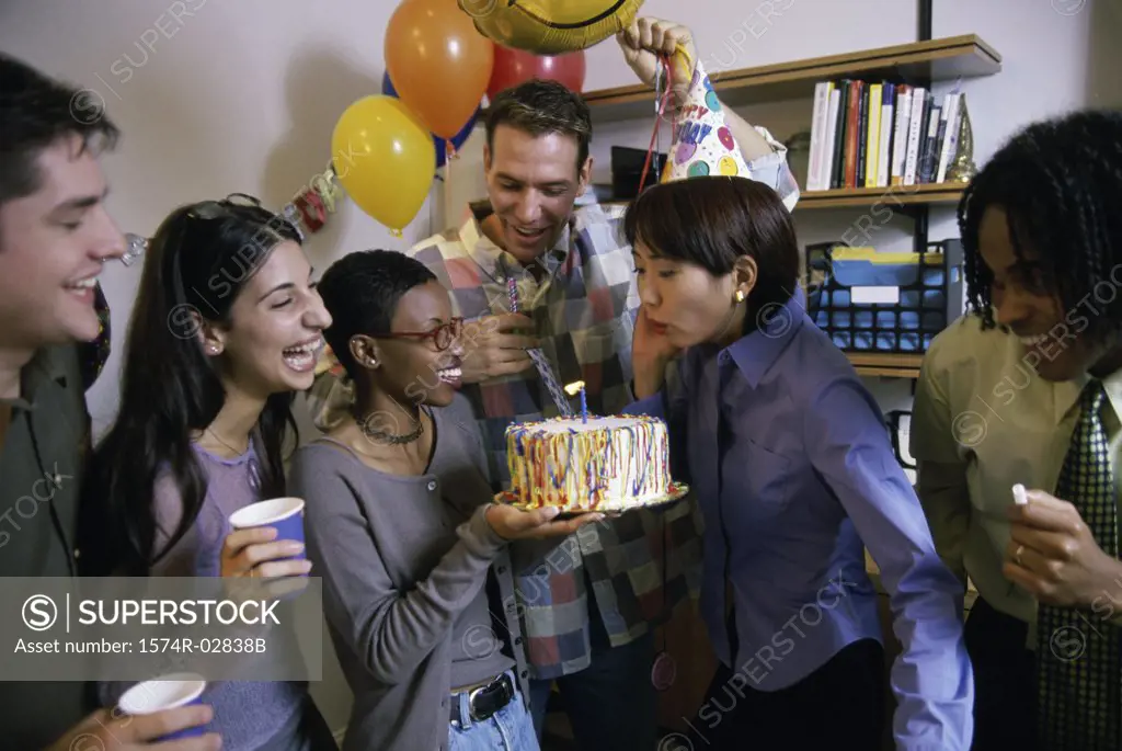 Group of business executives celebrating a birthday in the office