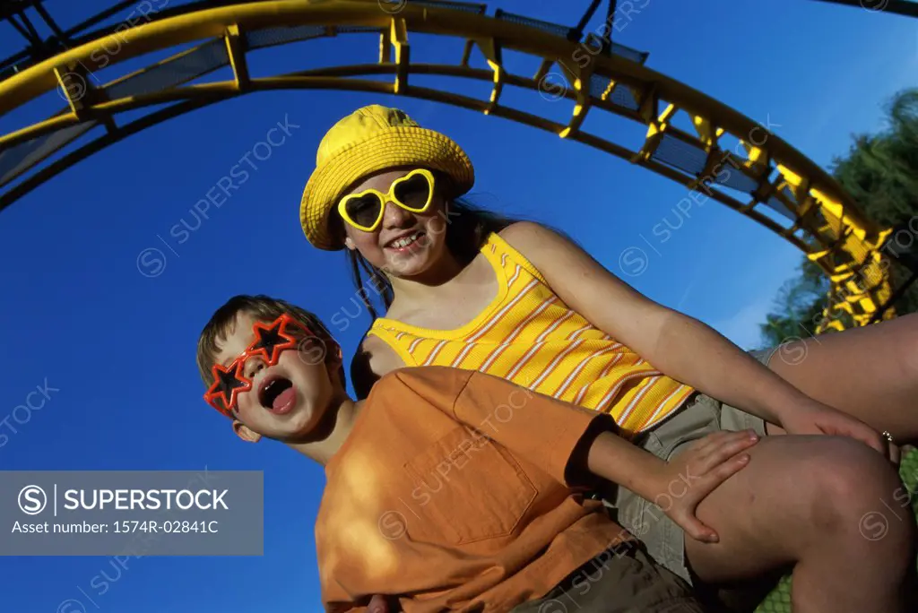 Low angle view of a boy and a girl in an amusement park