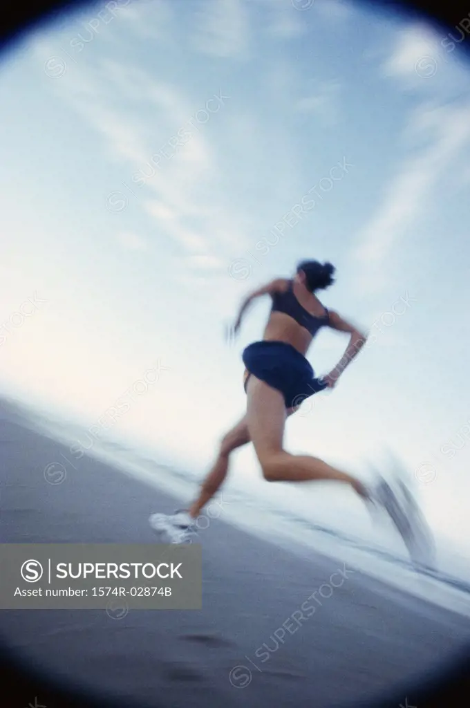Low angle view of a woman running on the beach