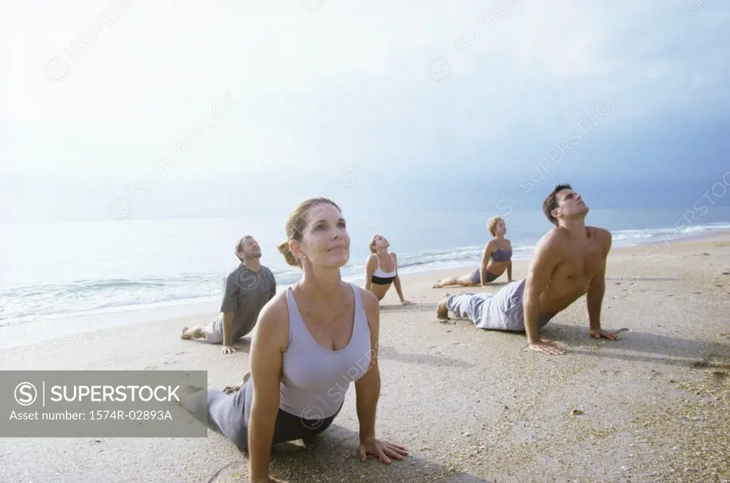 Group of people exercising on the beach