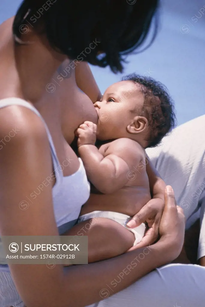 High angle view of a mother breastfeeding her baby boy