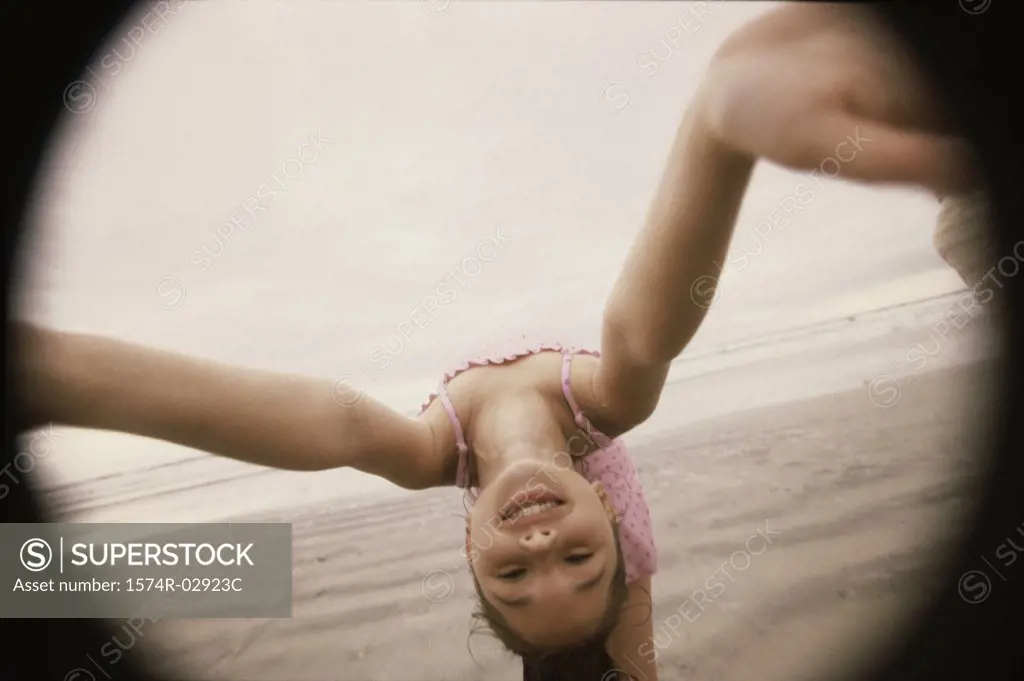 Girl bending over backwards on the beach