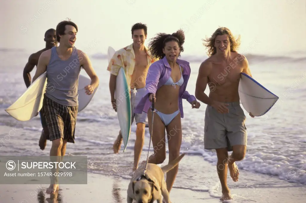 Group of young people running on the beach