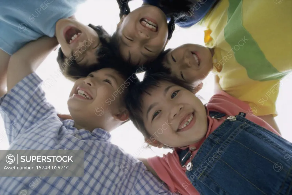 Low angle view of a group of children in a huddle