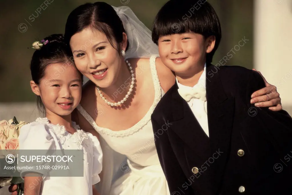 Portrait of a bride with a flower girl and a ring bearer