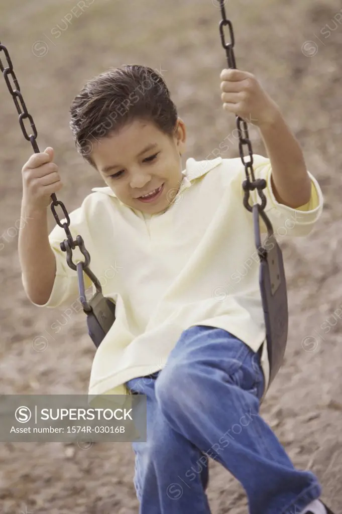 Boy sitting on a swing
