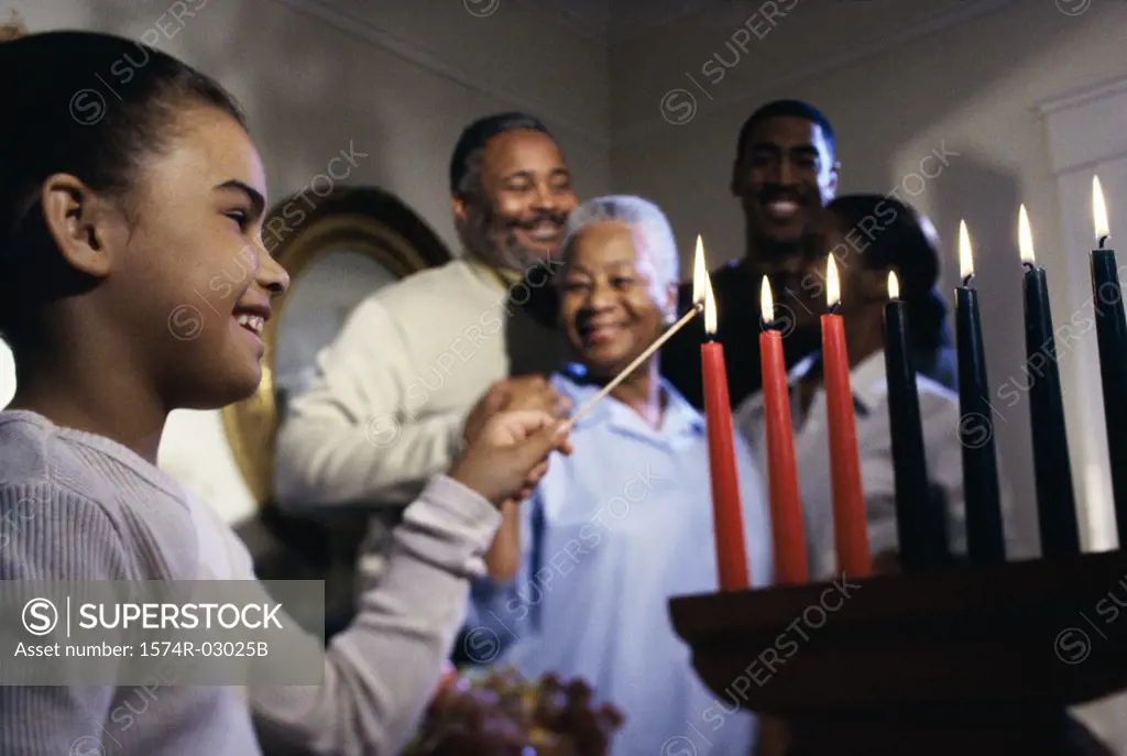 Girl lighting candles to celebrate Kwanzaa