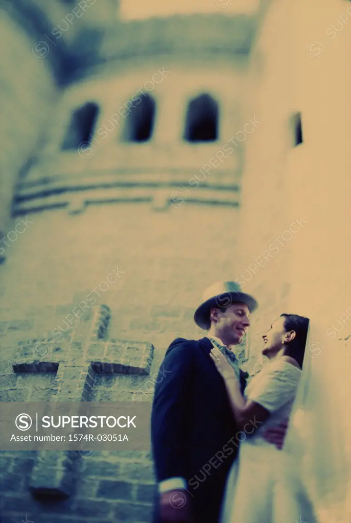 Low angle view of a newlywed couple embracing each other