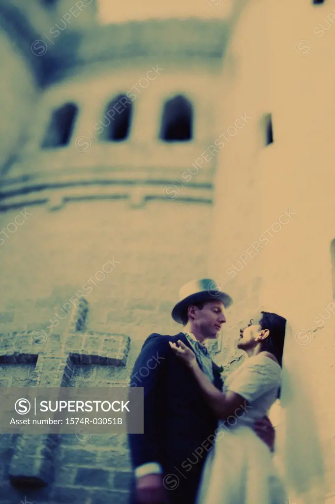 Low angle view of a newlywed couple embracing each other