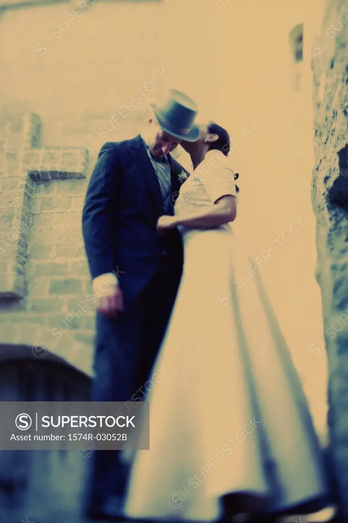 Low angle view of a bride whispering to her groom