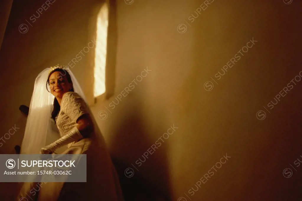 Portrait of a bride walking up stairs