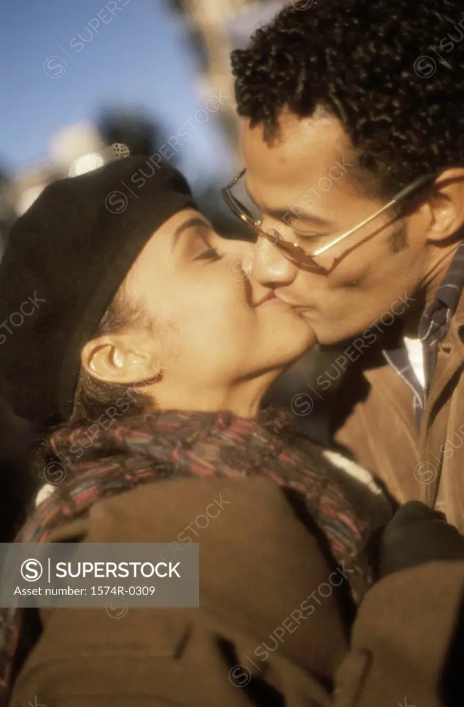 Young couple kissing with their eyes closed