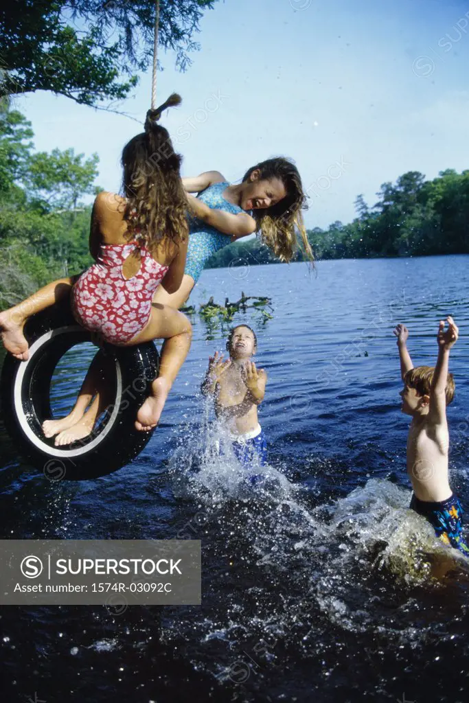 Group of children playing on a tire swing