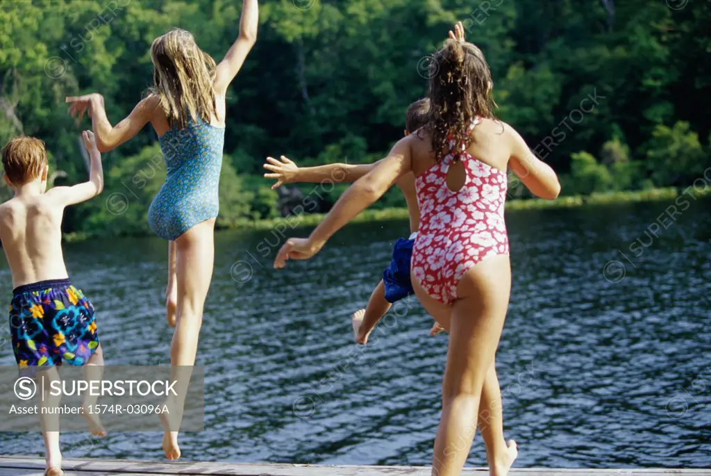 Group of children jumping into water