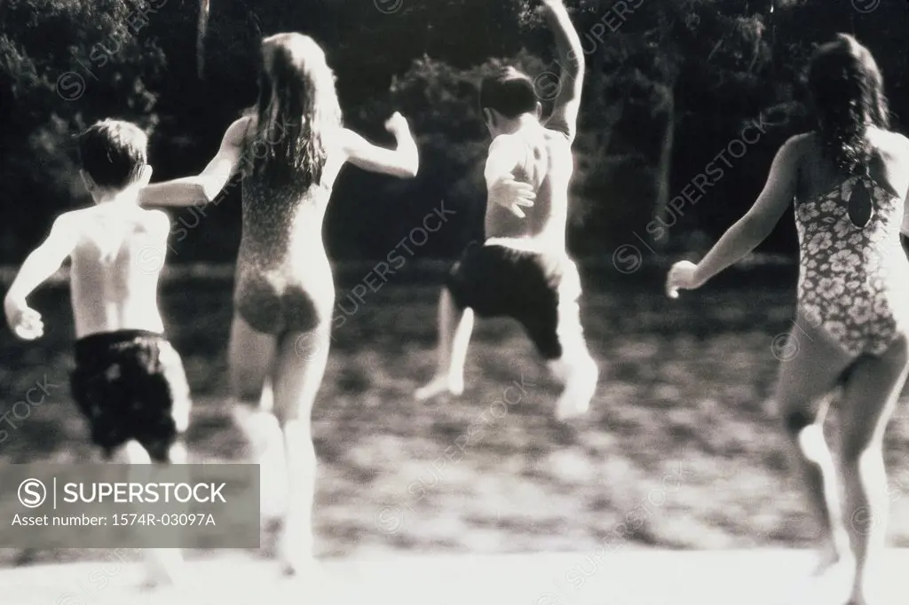 Group of children jumping into water