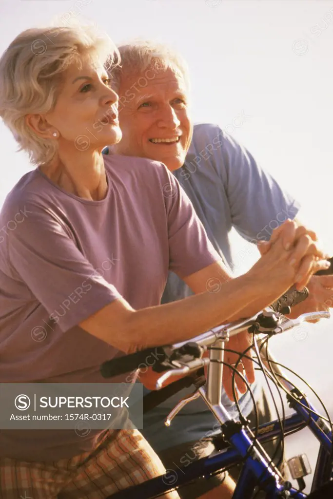 Senior couple standing with bicycles
