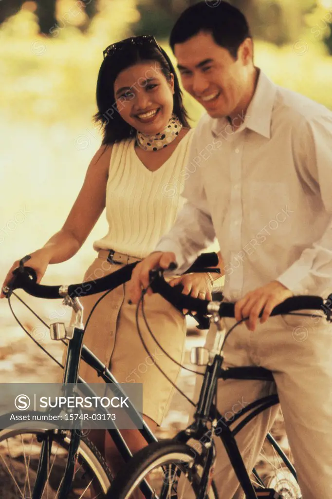 Young couple standing with bicycles