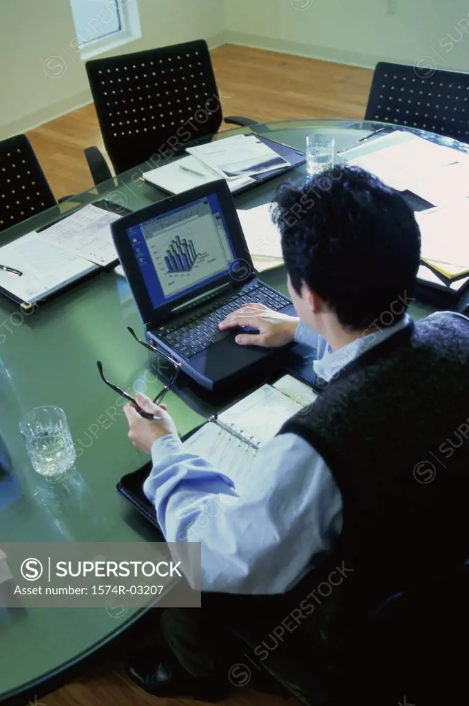 High angle view of a businessman operating a laptop