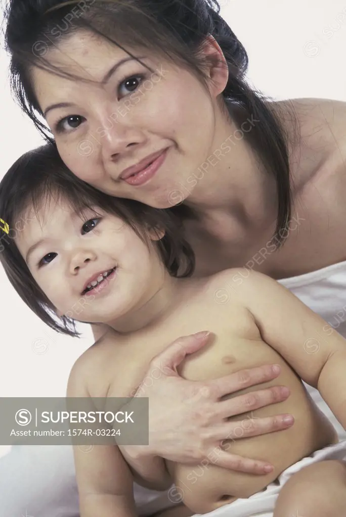 Portrait of a mother holding her baby girl