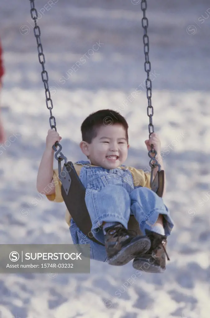 Boy playing on a swing