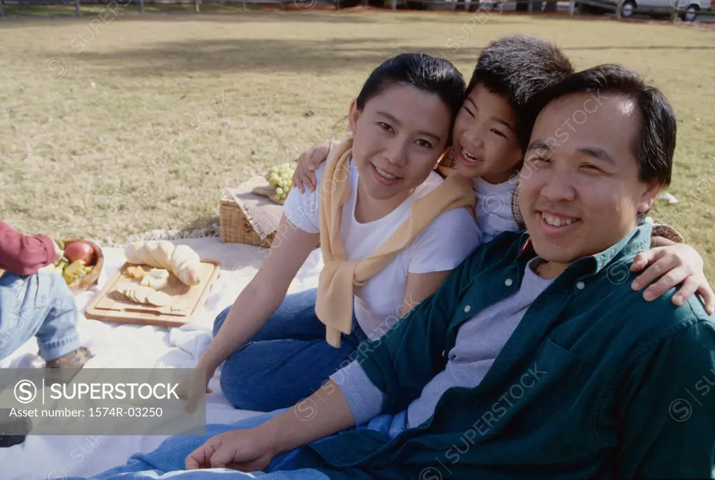 Portrait of parents with their son at a picnic