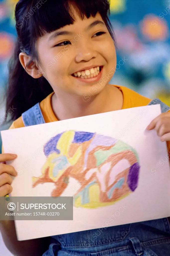Close-up of a girl holding a painting
