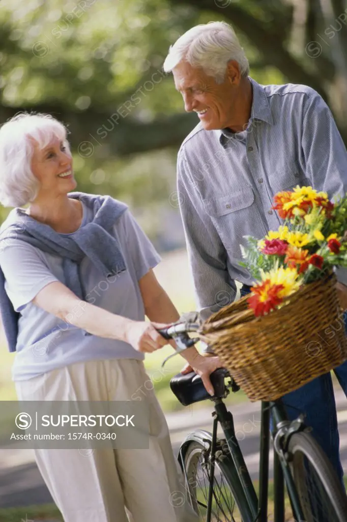 Senior couple standing with a bicycle