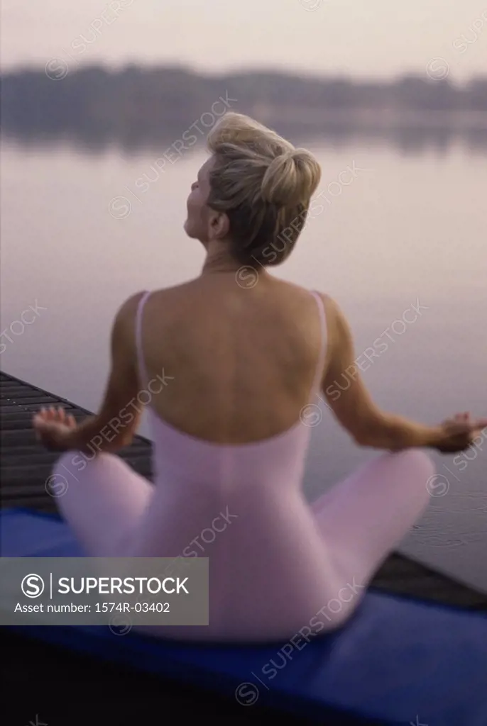 Rear view of a mid adult woman meditating