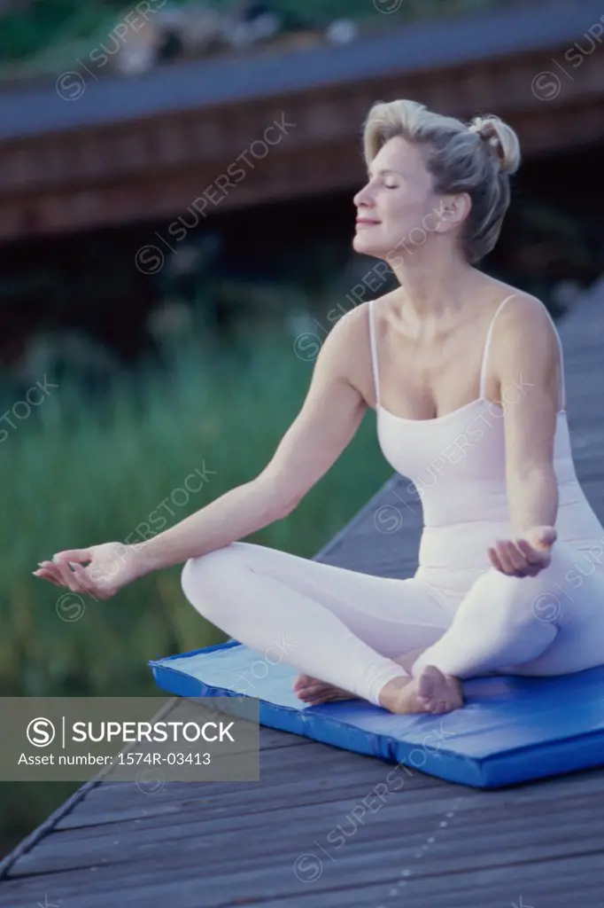 Mid adult woman meditating