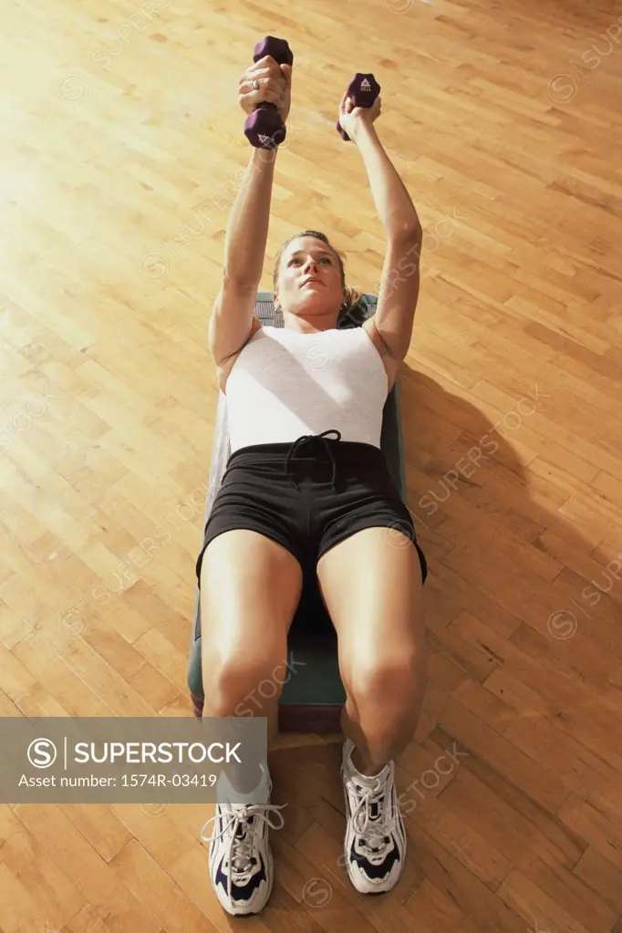 Young woman exercising in a step aerobics class
